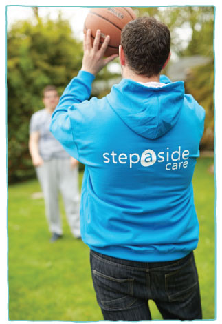Step-a-Side staff member throwing a ball to a care client